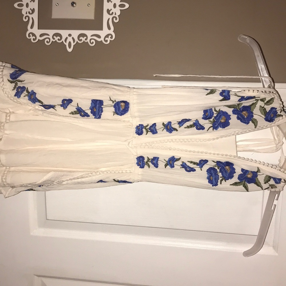 Romper. White. Blue. Flowers. Tie back. Flowy